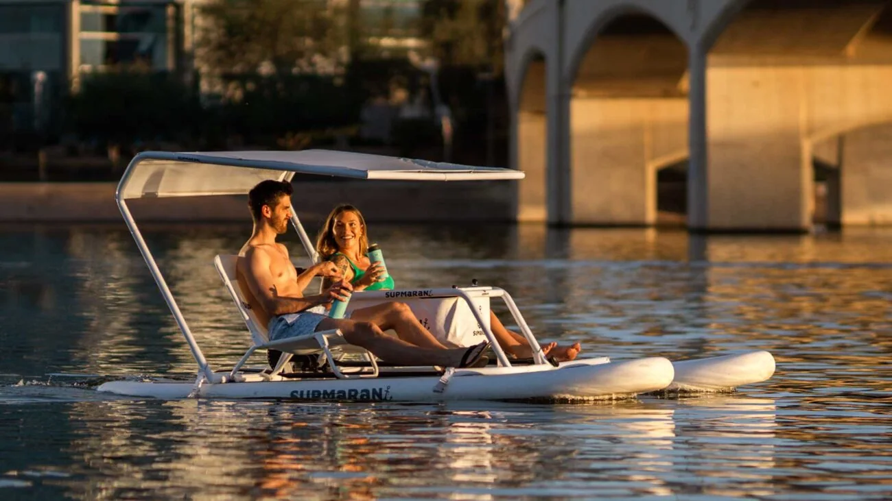 Couple enjoying a SUPMaRaN at sunset